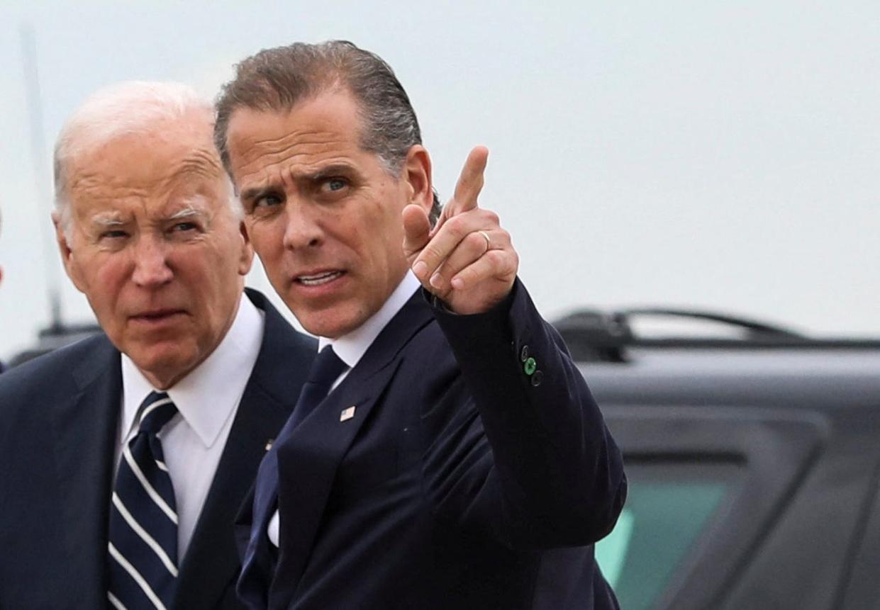 President Joe Biden stands with his son Hunter Biden, who earlier in the day was found guilty on all three counts in his criminal gun charges trial, after the president arrived at the Delaware Air National Guard Base in New Castle, Delaware, on June 11, 2024.