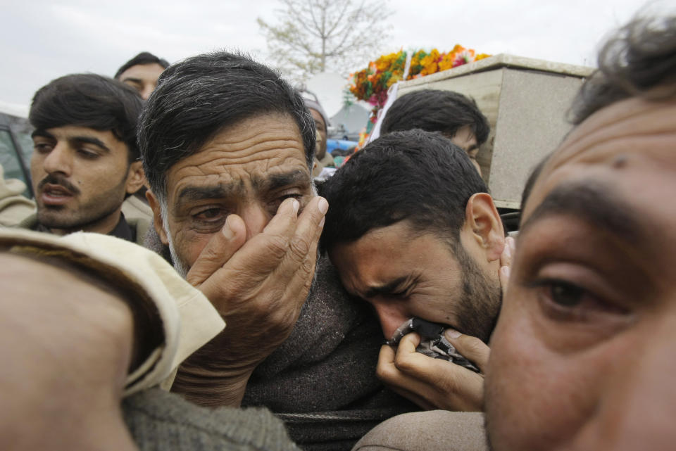 Relatives of a policeman who was killed in a bomb explosion, mourn his death, while taking his body for burial in Charsadda, Pakistan, Wednesday, Jan. 22, 2014. A bomb rigged to a bicycle struck a police patrol on its way to guard a polio vaccination team in northwestern Charsadda district, killing six, said officer Shafiullah Khan. (AP Photo/Mohammad Sajjad)