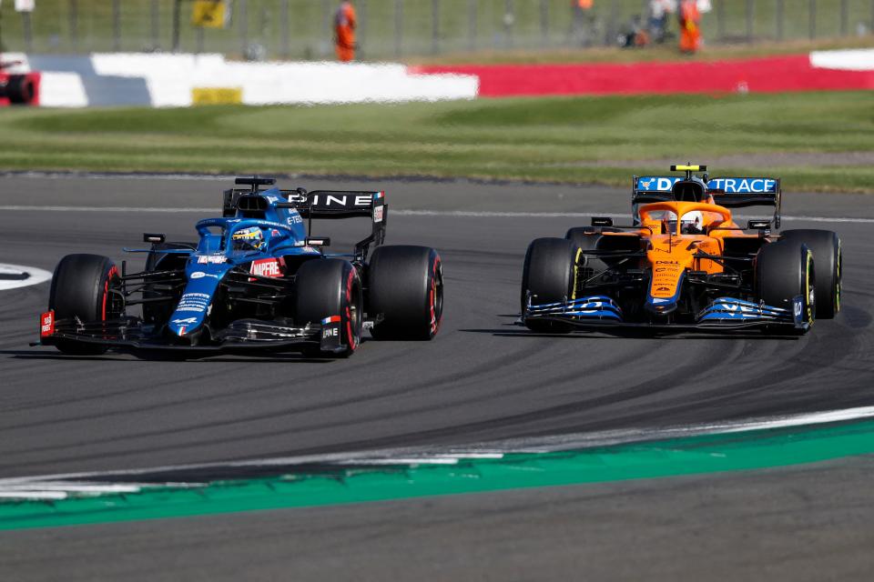 Alpine's Spanish driver Fernando Alonso (L) leads McLaren's British driver Lando Norris during the sprint session of the Formula One British Grand Prix at Silverstone motor racing circuit in Silverstone, central England on July 17, 2021. (Photo by Adrian DENNIS / AFP) (Photo by ADRIAN DENNIS/AFP via Getty Images)