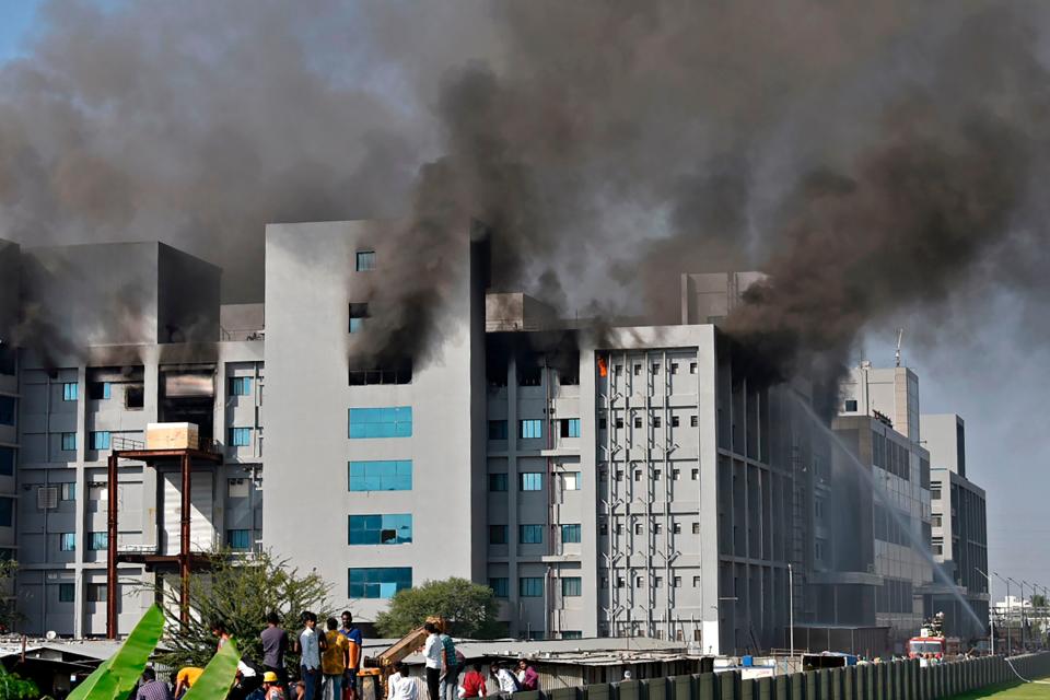 <p>Firefighters try to control a fire that broke out at India's Serum Institute in Pune </p> (AFP via Getty Images)