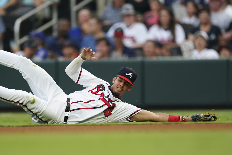 Atlanta Braves second baseman Vaughn Grissom cannot get to a ground ball by New York Mets' Jeff McNeil for a base hit in the first inning of a baseball game Monday, Aug. 21, 2023, in Atlanta. (AP Photo/John Bazemore)