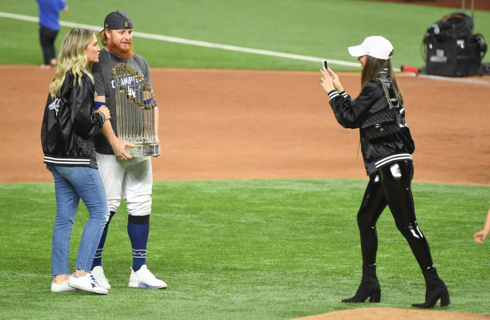 Justin Turner holds the Commissioner's Trophy next to his wife Kourtney Pogue after the Dodgers won the World Series.