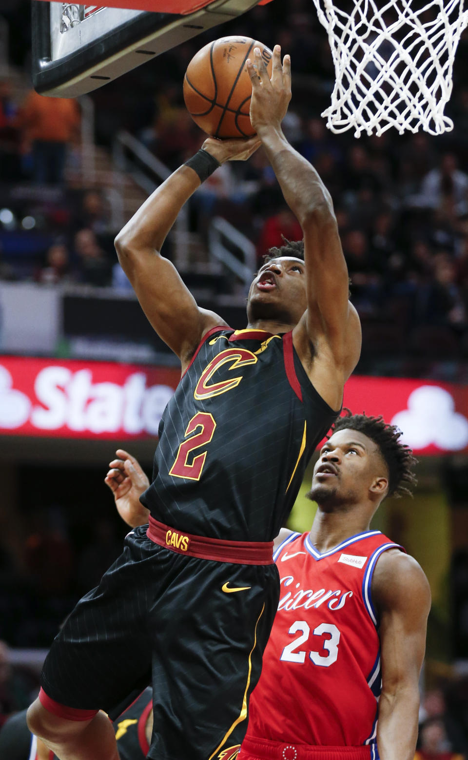 Cleveland Cavaliers' Collin Sexton (2) scores past Philadelphia 76ers' Jimmy Butler (23) during the first half of an NBA basketball game Sunday, Dec. 16, 2018, in Cleveland. (AP Photo/Ron Schwane)