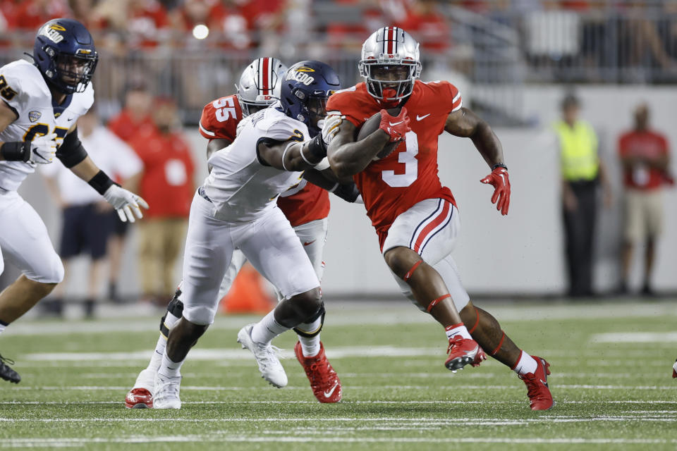 Ohio State running back Miyan Williams, right, cuts upfield against Toledo linebacker Dyontae Johnson during the first half of an NCAA college football game Saturday, Sept. 17, 2022, in Columbus, Ohio. (AP Photo/Jay LaPrete)