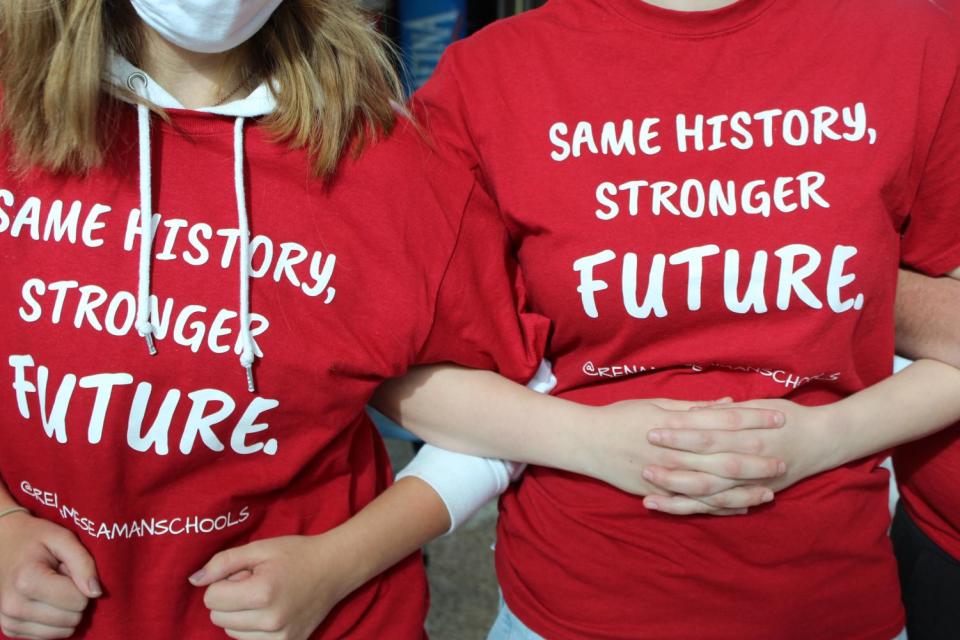 Two students interlock their hands and wear red shirts. Sophomore Kate Eckert, featured on the left, stated, “I think it was a show of solidarity between the students that still think this is an issue that matters.”