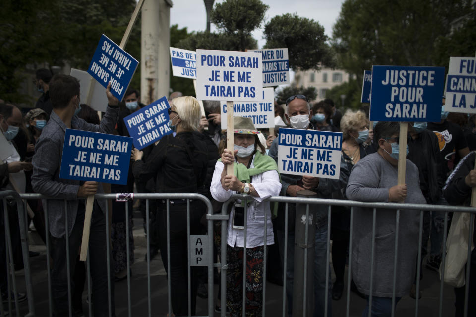 A protester holds a sign that reads "for Sarah I will never be silent" during a demonstration in Marseille, southern France, Sunday, April 25, 2021. Crowds gathered Sunday in Paris and other French cities to denounce a ruling by France's highest court that the killer of Jewish woman Sarah Halimi was not criminally responsible and therefore could not go on trial. (AP Photo/Daniel Cole)