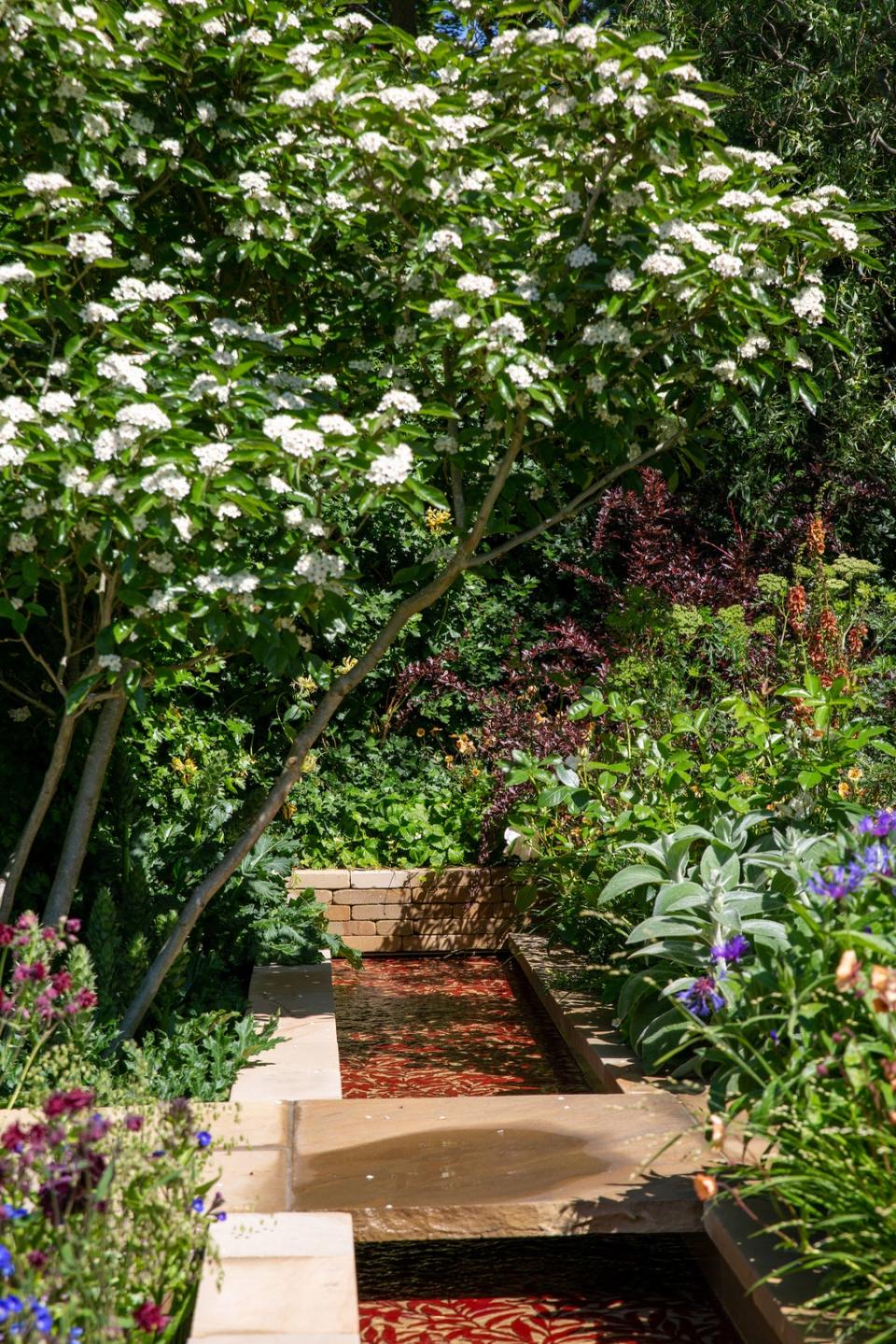 Repurposed paving offcuts were used in the Morris & Co show garden (Natalia Odescalchi/PA)