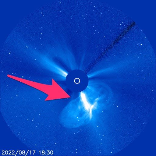 blue image shows white plasma erupting from dark circle where the sun is located