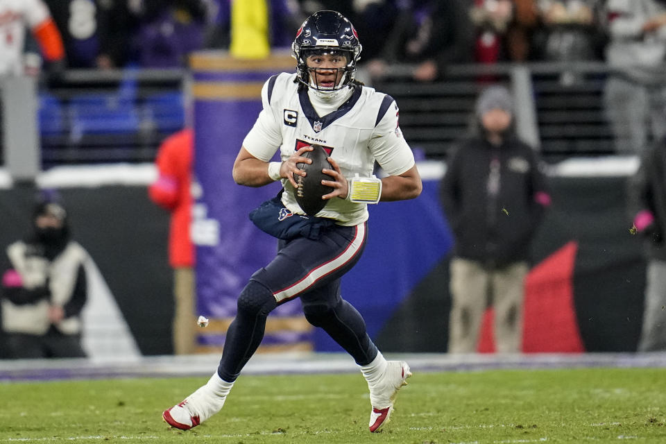 Houston Texans quarterback C.J. Stroud (7) rolls out of the pocket against the Baltimore Ravens during the second half of an NFL football AFC divisional playoff game, Saturday, Jan. 20, 2024, in Baltimore. (AP Photo/Julio Cortez)