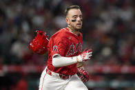 Los Angeles Angels' Zach Neto loses his helmet while running to first after grounding out to Minnesota Twins shortstop Willi Castro during the fourth inning of a baseball game Saturday, April 27, 2024, in Anaheim, Calif. (AP Photo/Ryan Sun)