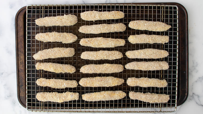 breaded chicken fries on rack