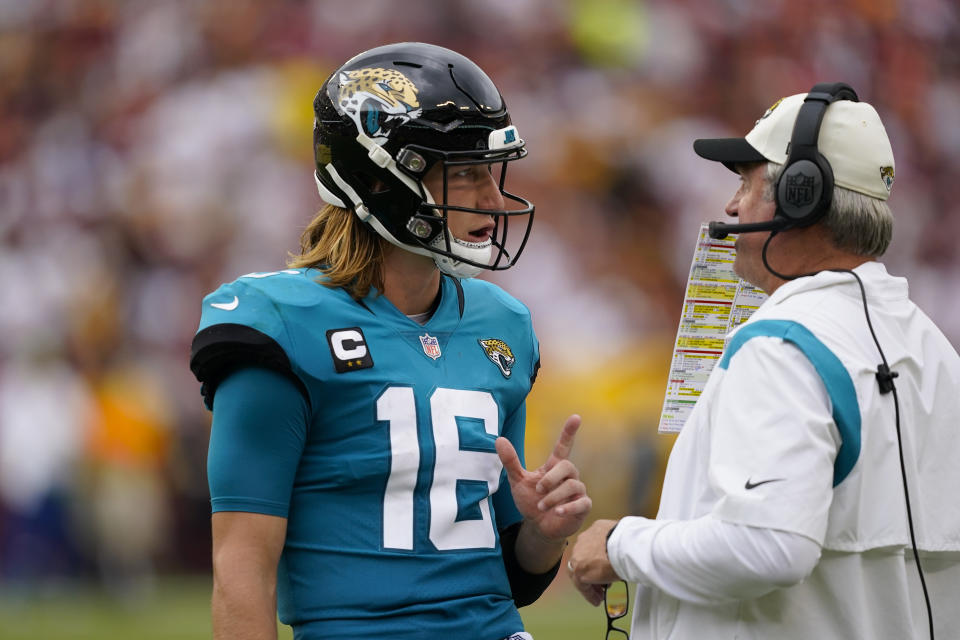 Jacksonville Jaguars quarterback Trevor Lawrence (16) talking with head coach Doug Pederson during the second half of an NFL football game, Sunday, Sept. 11, 2022, in Landover, Md. (AP Photo/Alex Brandon)