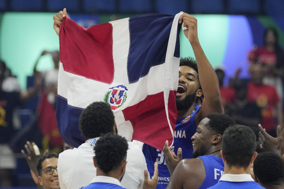 Dominican Republic forward Karl-Anthony Towns (32) and team celebrates after winning against Angola during their Basketball World Cup group A match at the Araneta Coliseum, Manila, Philippines on Tuesday, Aug. 29, 2023. (AP Photo/Aaron Favila)