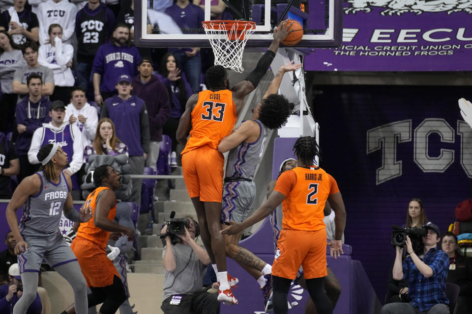 Oklahoma State forward Moussa Cisse (33) blocks a shot attemp by TCU guard Micah Peavy (0) in the first half of an NCAA college basketball game, Saturday, Feb. 18, 2023, in Fort Worth, Texas. (AP Photo/Tony Gutierrez)