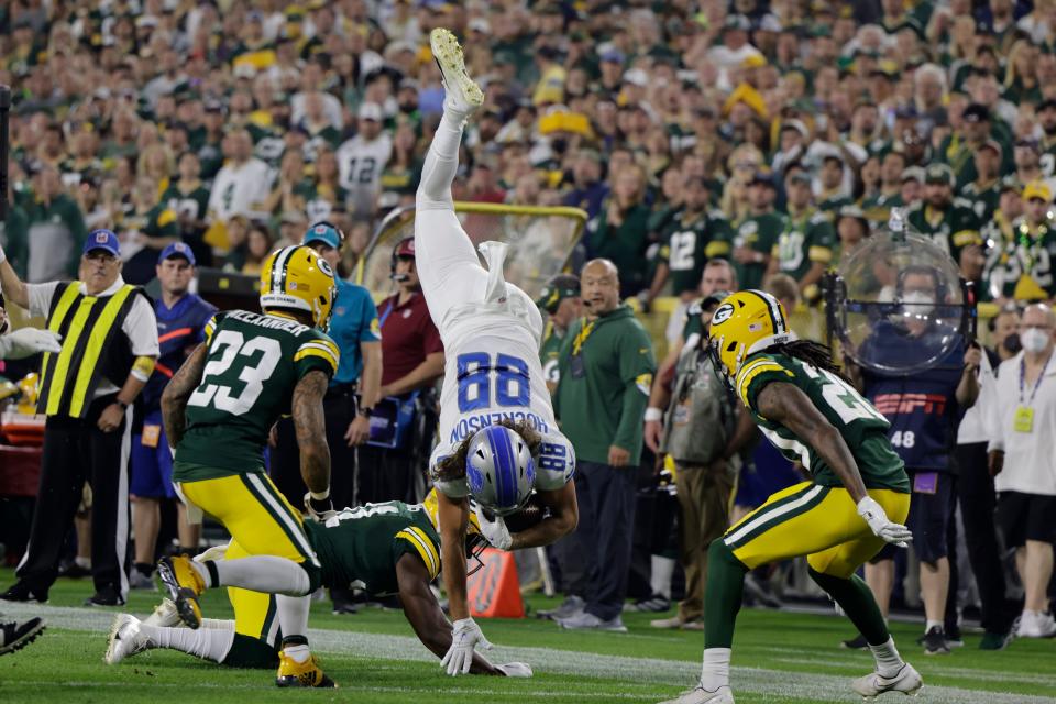 Green Bay Packers safety Adrian Amos upends Detroit Lions tight end T.J. Hockenson during the first half of the teams' Sept. 20 game at Lambeau Field.