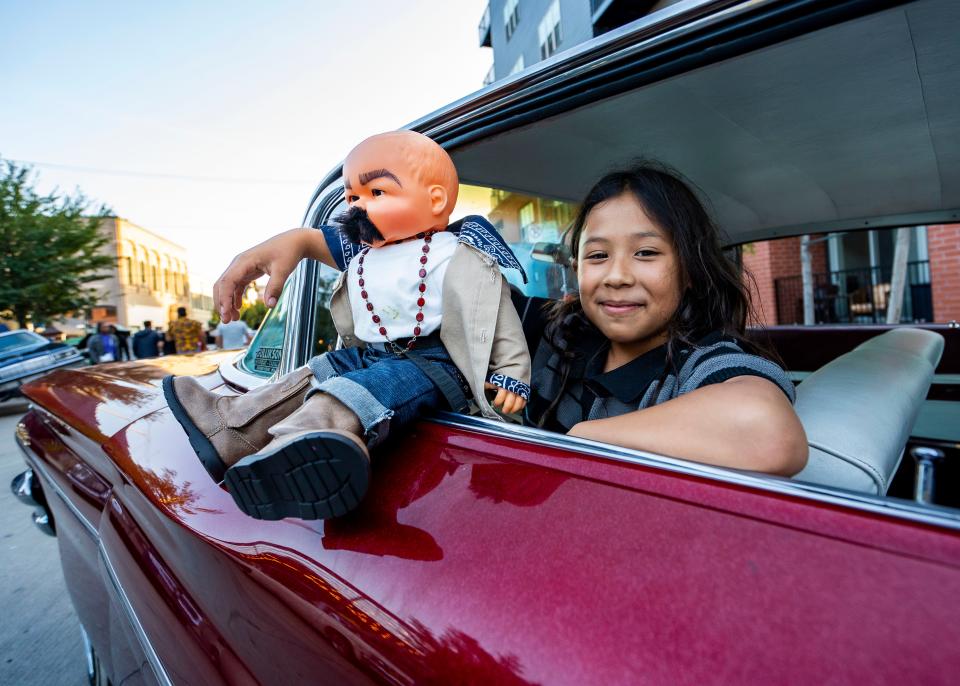 9-year-old Camila Sandoval, who was with parent Armando Sandoval, sits in her dad's custom car with her doll at the 5th Annual "El Grito en Calle 5" Car Show and Festival hosted by Ranflitas Milwaukee car club on Saturday September 23, 2023 in Milwaukee, Wis.