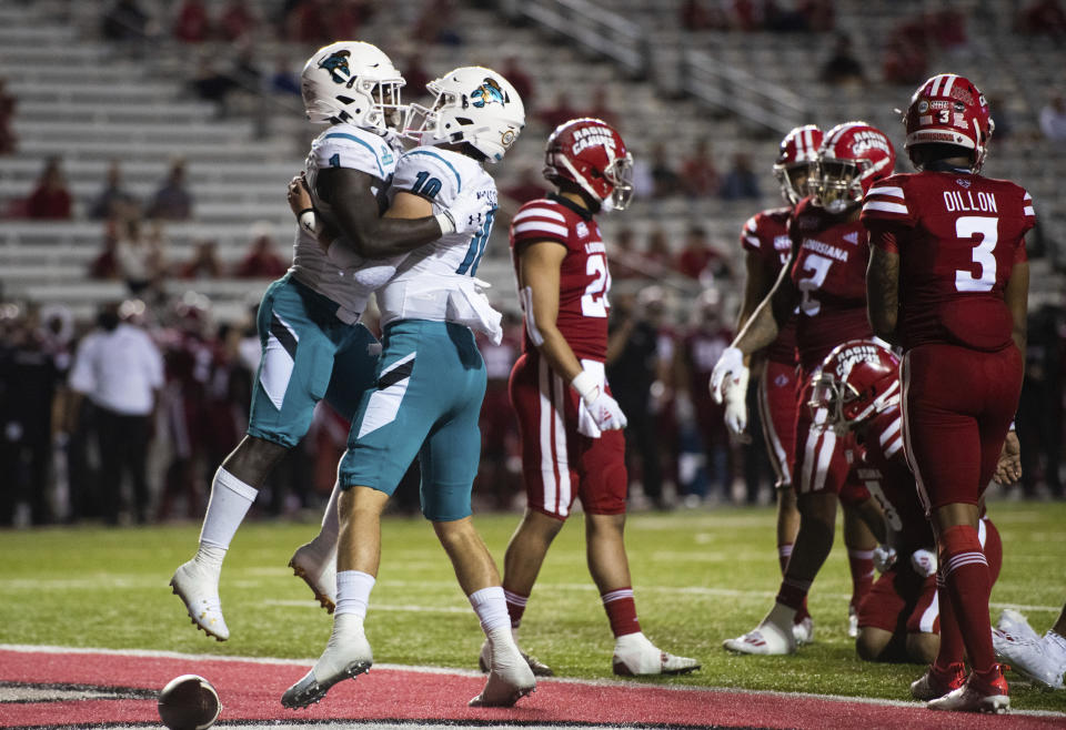 Coastal Carolina running back CJ Marable (1) and quarterback Grayson McCall (10) celebrate after Marable scored a touchdown during the first half of an NCAA football game against Louisiana-Lafayette in Lafayette, La., Wednesday, Oct. 14, 2020. (AP Photo/Paul Kieu)