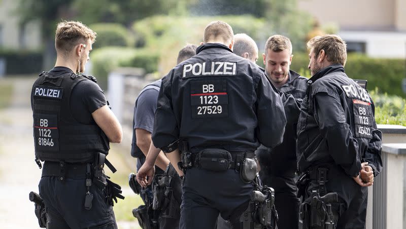 Police officers coordinate the search for a wild animal in a residential area in Teltow, Germany, Thursday July 20, 2023. German authorities warned people in Berlin’s southern suburbs on Thursday to watch out for a potentially dangerous animal, suspected to be a lioness, that was on the loose.