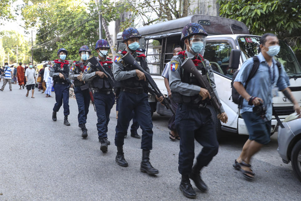 Police officers march to provide security as Buddhist monk Wirathu, arrives at a police station in Yangon, Myanmar, Monday Nov. 2, 2020. Wirathu, a nationalist Buddhist monk in Myanmar noted for his inflammatory rhetoric, has surrendered to police, who have been seeking his arrest for over a year for insulting comments he made about the country’s leader, State Counsellor Aung San Suu Kyi. (AP Photo/Thein Zaw)