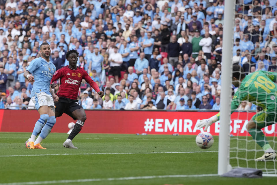 Manchester United's Kobbie Mainoo, second left, scores his side's second goal during the English FA Cup final soccer match between Manchester City and Manchester United at Wembley Stadium in London, Saturday, May 25, 2024. (AP Photo/Kin Cheung)