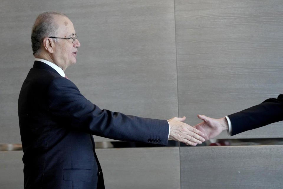 Prime Minister of the Palestinian Authority Mohammed Mustafa, left, reaches out to shake hands with Norway's Foreign Minister Espen Barth Eide prior to a meeting for talks on the Middle East in Brussels, Sunday, May 26, 2024. Norway on Sunday handed over papers to the Palestinian prime minister to officially give it diplomatic recognition as a state in a largely symbolic move that has infuriated Israel. (AP Photo/Virginia Mayo)