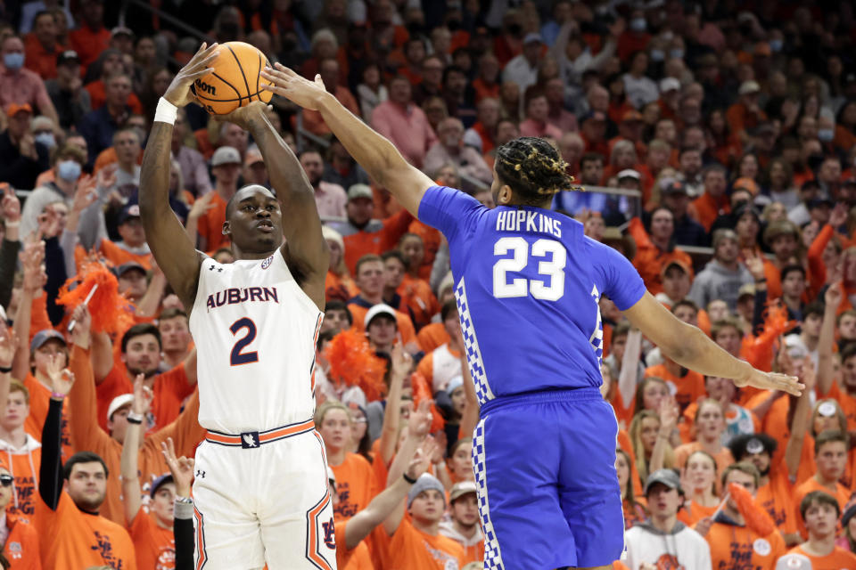 Auburn forward Jaylin Williams (2) shoots a three pointer as Kentucky forward Bryce Hopkins (23) defends during the second half of an NCAA college basketball game Saturday, Jan. 22, 2022, in Auburn, Ala. (AP Photo/Butch Dill)