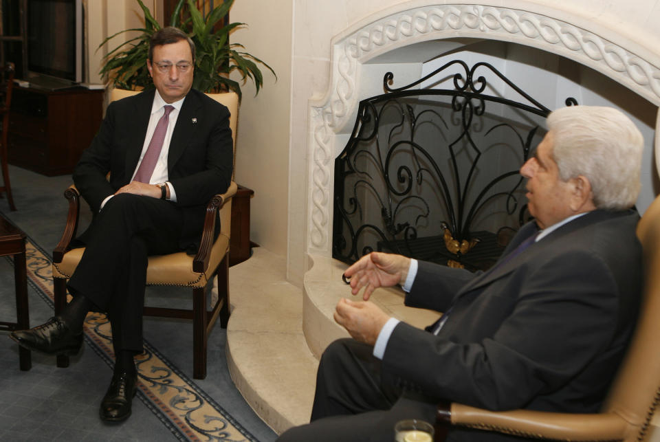 European Central Bank chief Mario Draghi, left, speaks with Cyprus President Dimitris Christofias at the Cypriot Presidential Palace on the sidelines of an informal meeting of European finance ministers in the Cypriot capital, Friday, Sept. 14, 2012. Spain appeared Friday to be inching closer to making a formal request for financial help, while Greece’s euro partners gave a big hint that the heavily-indebted country may get more time, but not money, to get its public finances into shape. (AP Photo/Philippos Christou)