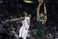 Boston Celtics forward Jayson Tatum (0) takes a shot against Miami Heat center Bam Adebayo (13) during the first half of an NBA basketball game, Tuesday, Jan. 24, 2023, in Miami. (AP Photo/Wilfredo Lee)