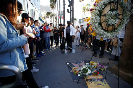 People gather around the star of late Marvel Comics co-creator Stan Lee on the Hollywood Walk of Fame in Los Angeles, California, U.S., November 12, 2018. REUTERS/Mario Anzuoni