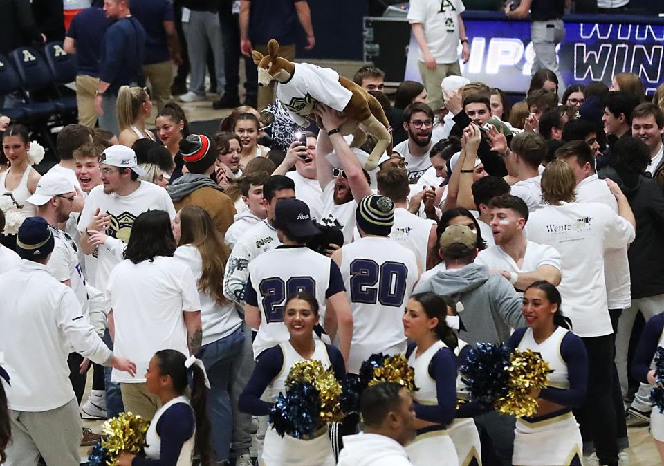 Akron fans celebrate the Zips' 67-55 victory over Kent State Friday night at Rhodes Arena.