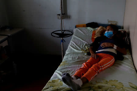 Yasmira Castano, 40, who lost her transplanted kidney, lies on a bed at a state hospital in Caracas, Venezuela February 7, 2018. REUTERS/Carlos Garcia Rawlins