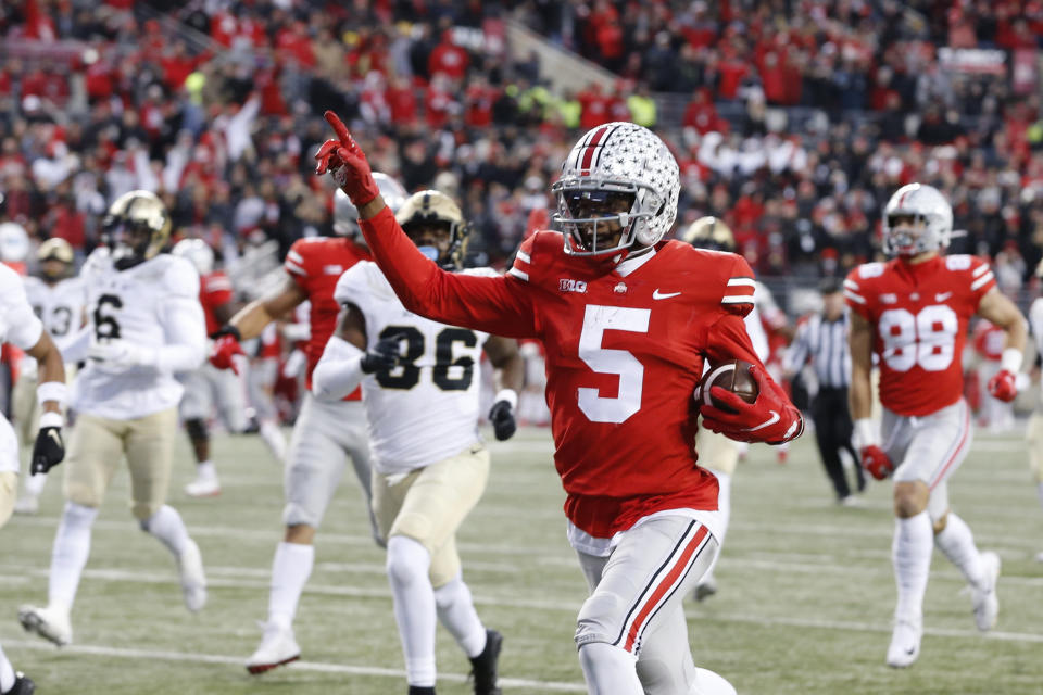 Ohio State receiver Garrett Wilson celebrates as he scores a touchdown against Purdue during the first half of an NCAA college football game, Saturday, Nov. 13, 2021, in Columbus, Ohio. (AP Photo/Jay LaPrete)