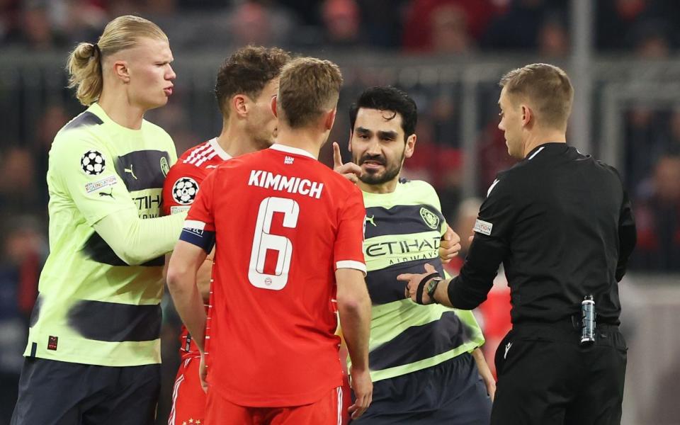 Ilkay Guendogan of Manchester City celebrates with Joshua Kimmich of FC Bayern Munich as Referee Clement Turpin steps in during the UEFA Champions League quarterfinal second leg match between Bayern Munich and Manchester City - Getty Images/Alexander Hassenstein