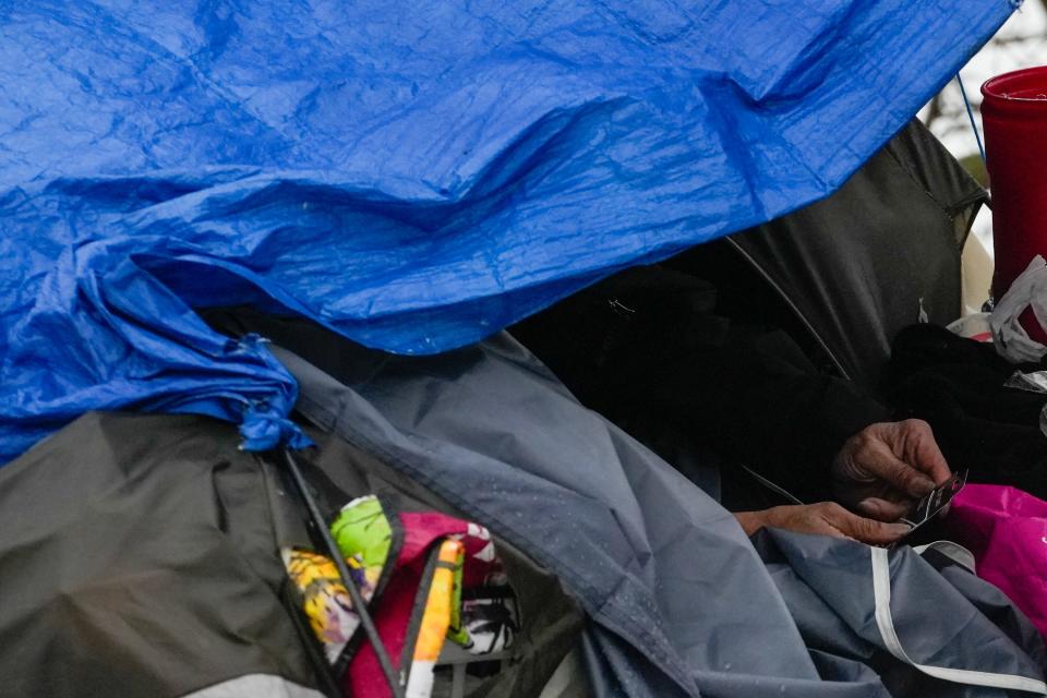 A man holds a Quick Trip gift card given to him for being part of the part of the point in time (PIT) count of individuals facing homelessness on Thursday, Jan. 25, 2024, in Des Moines.