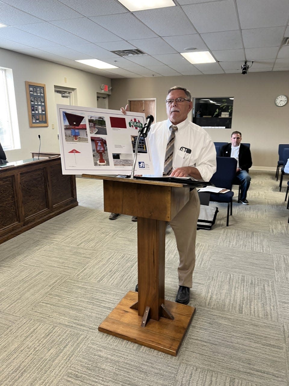 Ed Begue, an architect with Baker, Bednar, Snyder and Associates of Warren, shows off plans for an Rita's Italian Ice in Streetsboro.