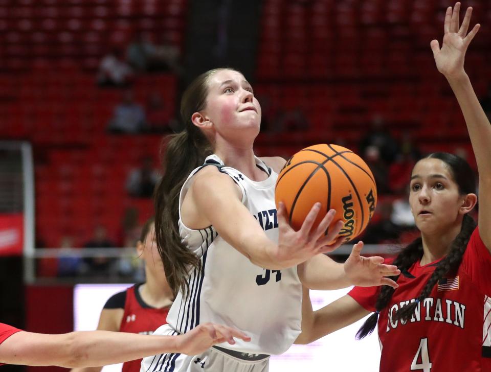 Copper Hills’ Skylie Barker shoots as Mountain Ridge’s Jessica Maynard guards her during a 6A girls quarterfinal basketball game at the Huntsman Center in Salt Lake City on Monday, Feb. 26, 2024. Copper Hills won 49-31. | Kristin Murphy, Deseret News