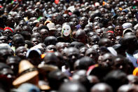 <p>A man wears a mask among fellow supporters as Kenyan opposition leader Raila Odinga (not pictured) takes a symbolic presidential oath of office in Nairobi, Kenya, Jan. 30, 2018. (Photo: Baz Ratner/Reuters) </p>