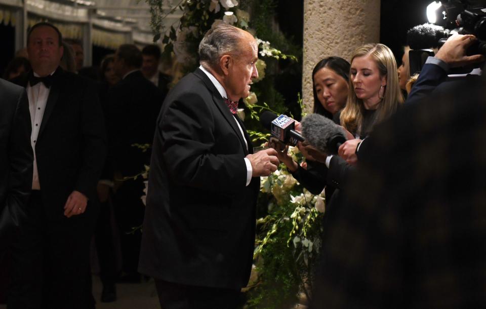 Rudy Giuliani stops to answer questions from the media at Mar-a-Lago before a New Year's Eve celebration in 2019 with President Trump. [JIM RASSOL/palmbeachpost.com]