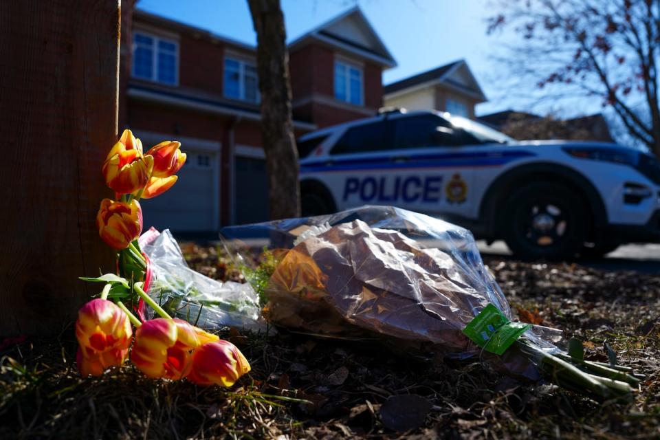 Flowers sit at the scene of a homicide where six people were found dead in the Barrhaven suburb of Ottawa on Thursday. (Sean Kilpatrick/The Canadian Press - image credit)