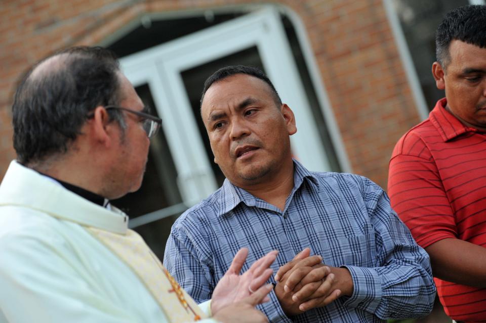 Felix Ramirez, center, and Eduardo Perez, right, both parishioners of St. Michael's Catholic Church in Morton, Mississippi, discuss the affect the Aug. 7, 2019, Immigration and Customs Enforcement raids in Morton have had on their families and the Latino community as a whole. The Rev. Ricardo Mena, left, pastor at St. Michael's, translates.
