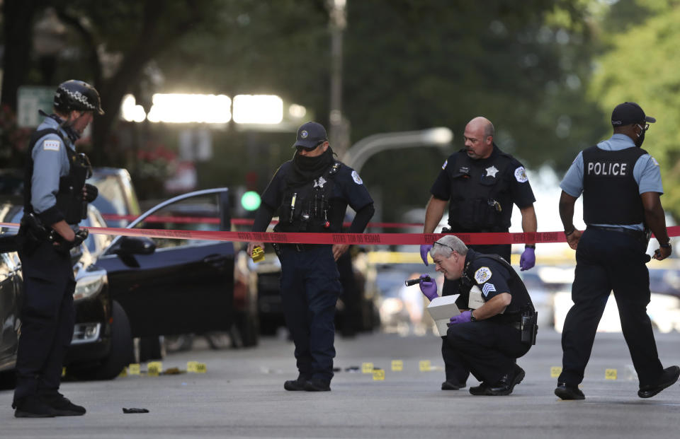 Chicago police investigate the scene of a shooing Tuesday, Aug. 4, 2020, on Oak Street in Chicago. The shooting left one person dead and two inured, authorities said. (Chris Sweda/Chicago Tribune via AP)