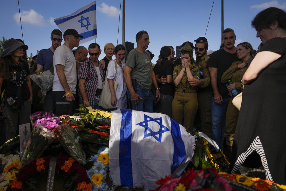 Mourners attend the funeral of Israeli soldier, Noa Marciano, in Modiin, Israel, Friday, Nov. 17, 2023. The Israeli military said Marciano's body was found in a building near Shifa Hospital in the Gaza Strip and brought to Israel for identification by the military rabbinate. Marciano is one of three hostages declared dead since October 7. (AP Photo/Ohad Zwigenberg)