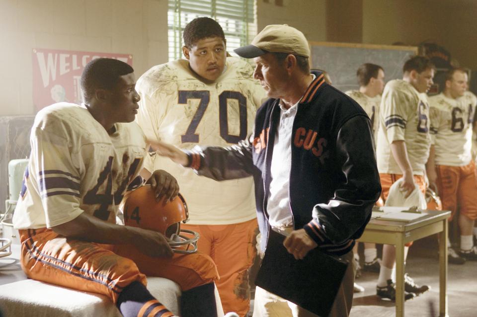 Rob Brown (left, with Omar Benson Miller and Dennis Quaid) stars as Ernie Davis, the first African-American to win the Heisman Trophy and the subject of "The Express."