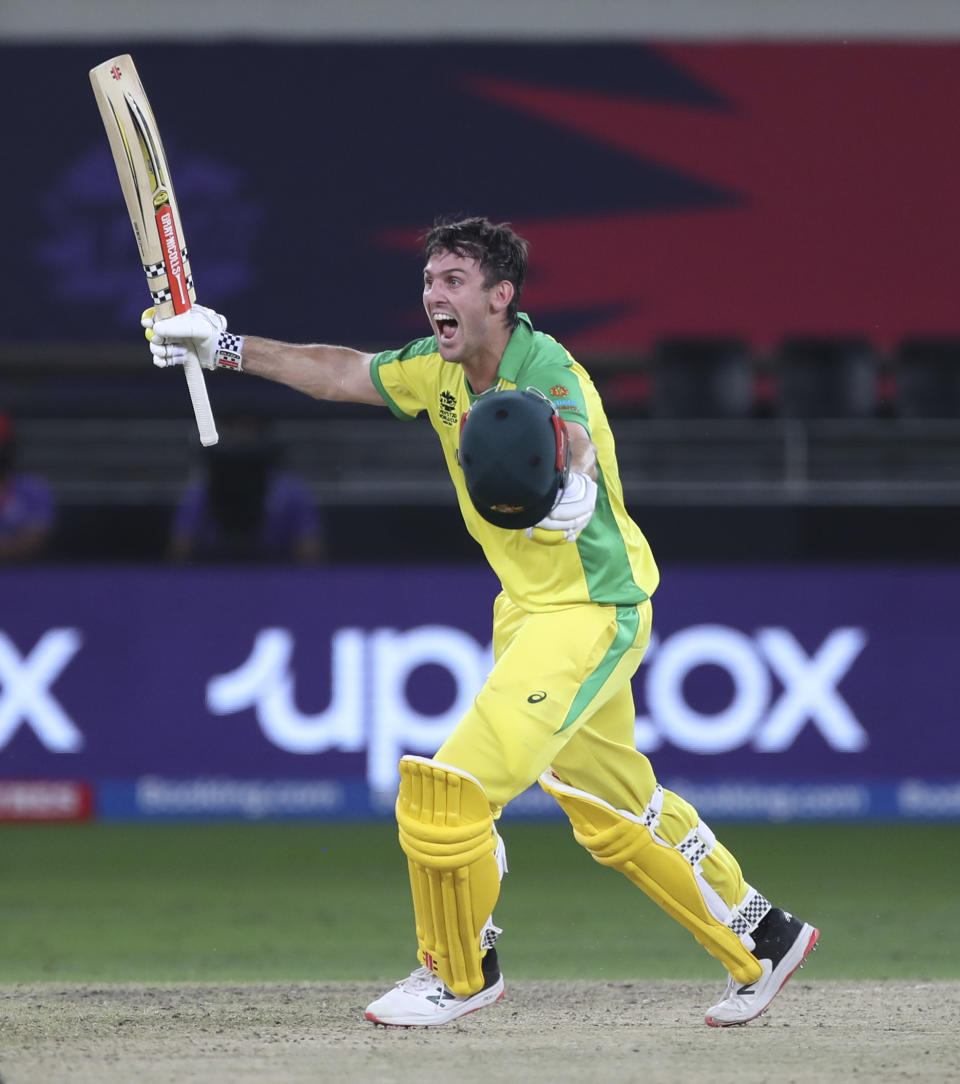 Australia's Mitchell Marsh run towards teammate Glenn Maxwell to celebrate after winning the Cricket Twenty20 World Cup final match between New Zealand and Australia in Dubai, UAE, Sunday, Nov. 14, 2021. (AP Photo/Aijaz Rahi)