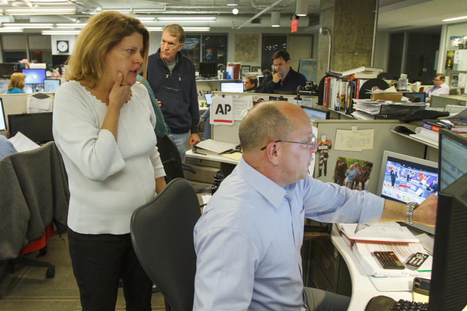 Then-Associated Press Washington bureau chief Sally Buzbee, talks with Stephen Ohlemacher, who in 2020 is the decision desk editor, in the early morning hours of Wednesday, Nov. 9, 2016, at the Washington bureau of The Associated Press during election night. The Associated Press, one of several news organizations whose declarations of winners drive election coverage, is pulling back the curtain in 2020 to explain how it is reaching those conclusions. “The general public has a more intense desire to understand it at a nitty-gritty level,” said Buzbee, who is now senior vice president and executive editor. (AP Photo/Jon Elswick)