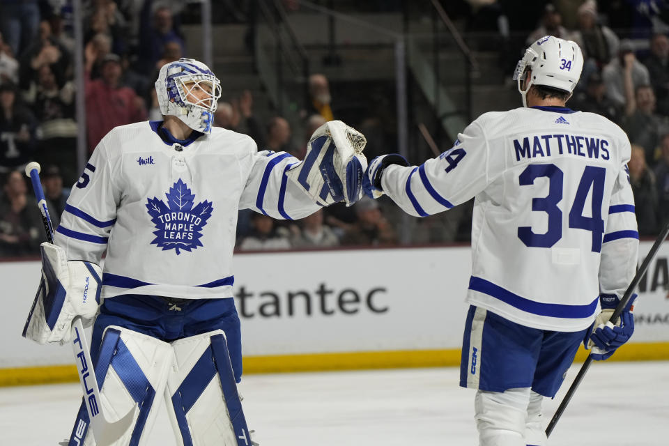 Toronto Maple Leafs center Auston Matthews (34) celebrates with goaltender Ilya Samsonov after scoring a goal against the Arizona Coyotes during the first period of an NHL hockey game, Wednesday, Feb. 21, 2024, in Tempe, Ariz. (AP Photo/Rick Scuteri)