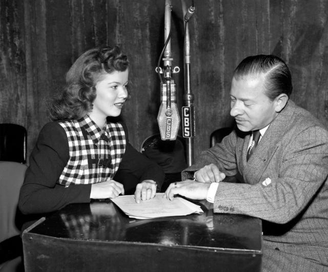 Shirley Temple posing by a painting of young Shirley Temple. 1945 :  r/OldSchoolCool