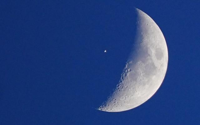 The International Space Station looking like a white dot as it passes the Moon - Peter Byrne