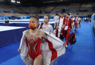 FILE - In this July 25, 2021, file photo, members of team China walk to the next apparatus during the women's artistic gymnastic qualifications at the 2020 Summer Olympics in Tokyo. Tokyo Olympians are exercising extraordinary discipline against the coronavirus. They are sealed off in a sanitary bubble that has made competition possible but is also squeezing a lot of fun from their Olympic experience. (AP Photo/Ashley Landis, File)