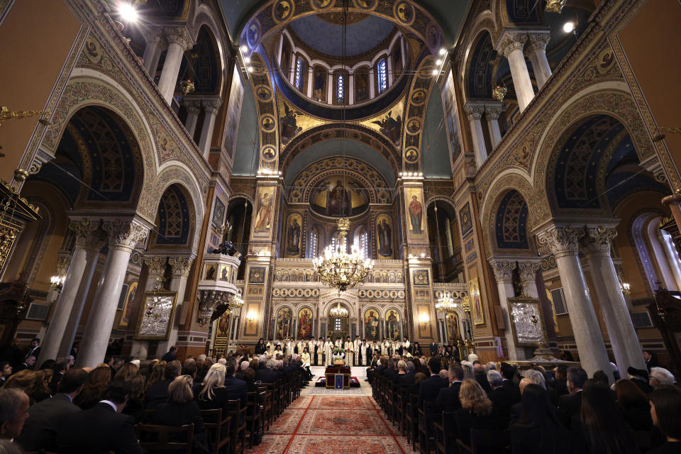 People attend the funeral service of the former king of Greece Constantine II at Metropolitan Cathedral in Athens, Monday, Jan. 16, 2023. Constantine died in a hospital late Tuesday at the age of 82 as Greece's monarchy was definitively abolished in a referendum in December 1974. (Stoyan Nenov/Pool via AP)